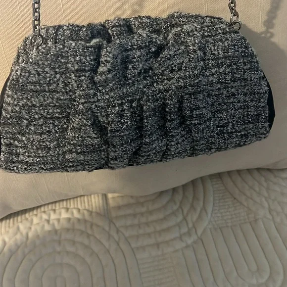 Shades of woven gray, and silver and black leather trim.Removable silver chain